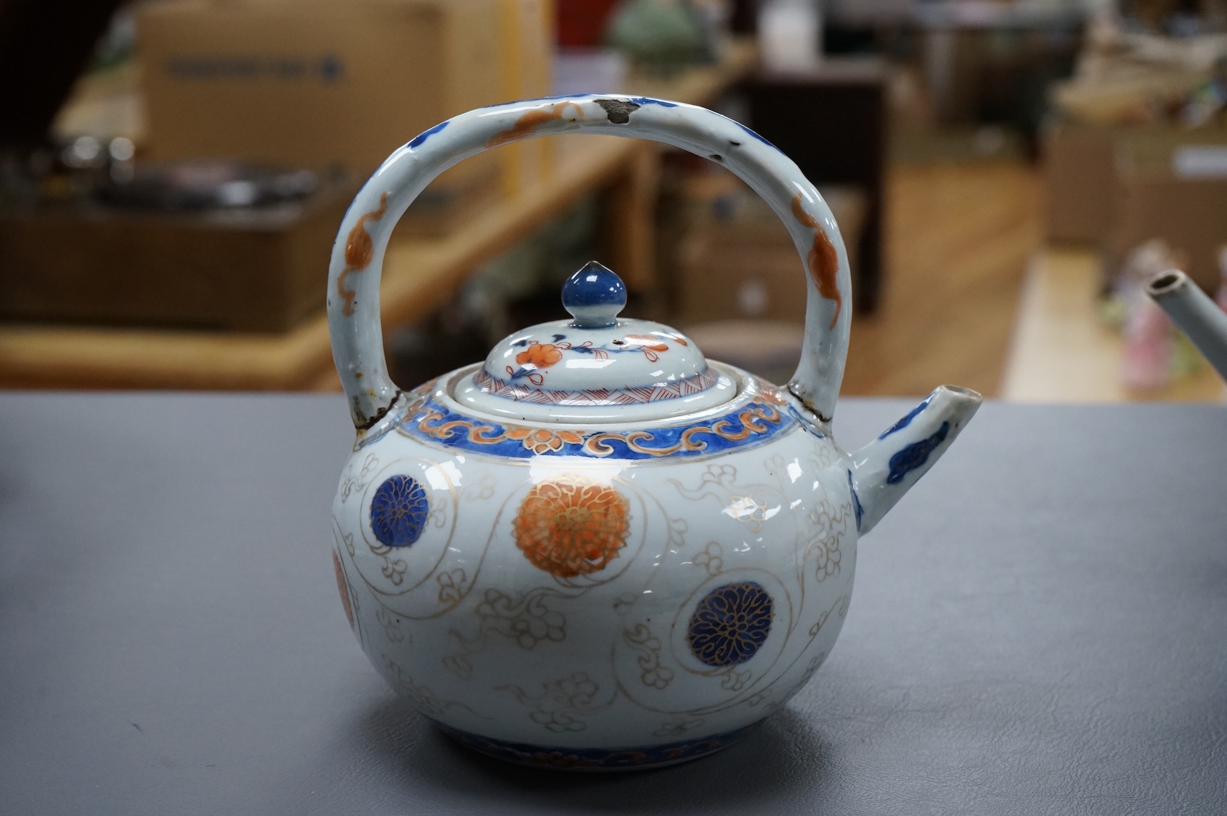 A Chinese famille rose ‘boys and ladies’ teapot, Qianlong period and a Japanese Arita sake pot or ewer, early 18th century, tallest 16cm high.